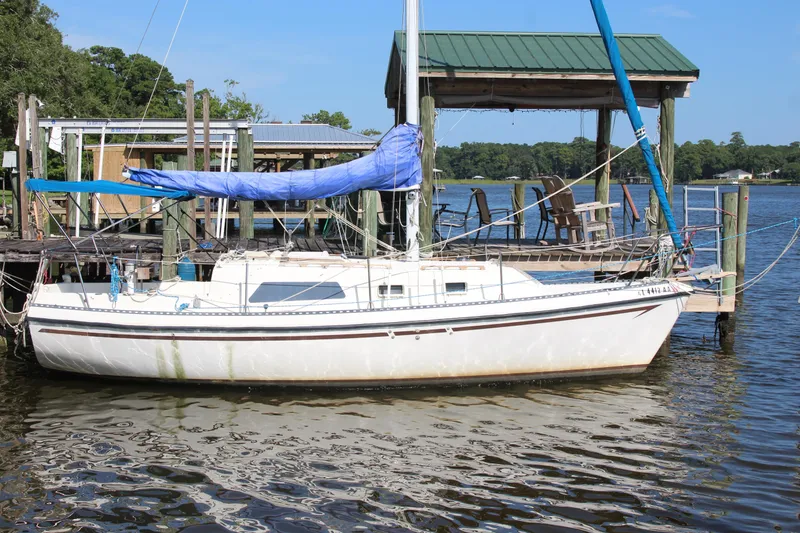 Slide: The Image of 1980 Watkins MONOHULL sailboat docked by a wooden pier on a sunny day. - 21