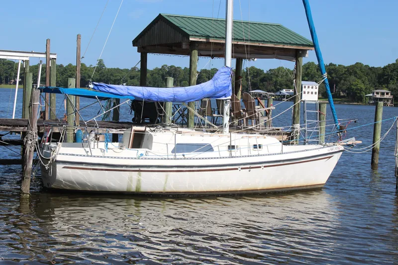 Slide: The Image of 1980 Watkins MONOHULL sailboat docked by a wooden pier on a sunny day. - 22