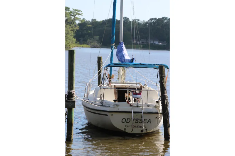 Slide: The Image of 1980 Watkins MONOHULL sailboat docked on a calm lake. - 25