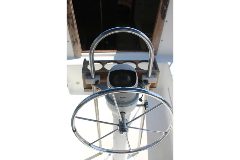 Slide: The Image of Steering wheel of a 1980 Watkins MONOHULL sailboat, featuring a classic design. - 8