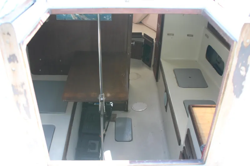 Slide: The Image of Interior view of a 1980 Watkins MONOHULL sailboat cabin, featuring seating and storage areas. - 9