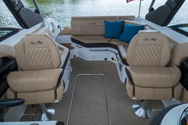 Slide: The Image of 2020 Sea Ray SLX 250 boat with tan cushioned seating and cup holders. - 10