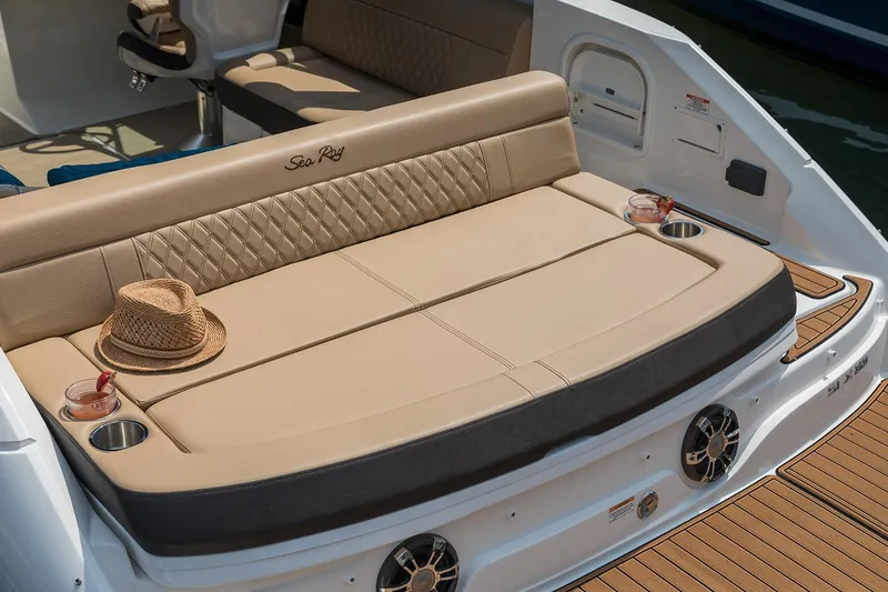 Slide: The Image of 2020 Sea Ray SLX 250 boat interior with tan seating and cup holders. - 11