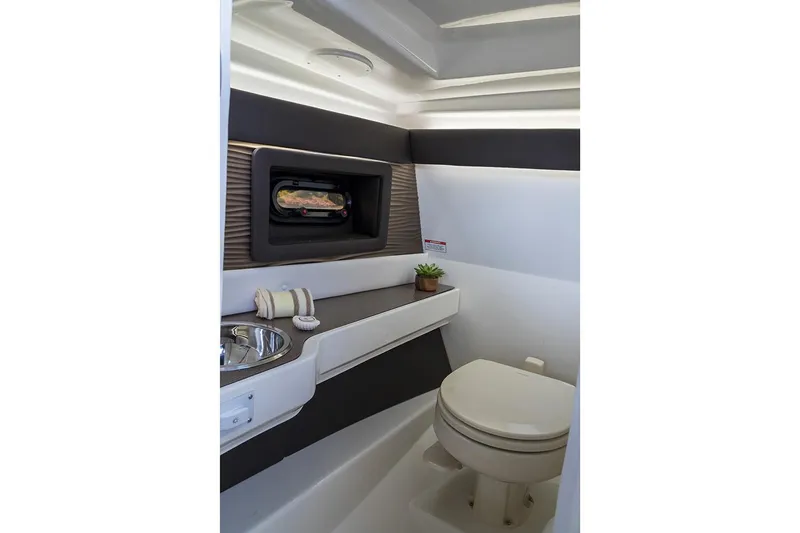 Slide: The Image of 2020 Sea Ray SLX 250 boat interior with tan seating and modern design. - 13