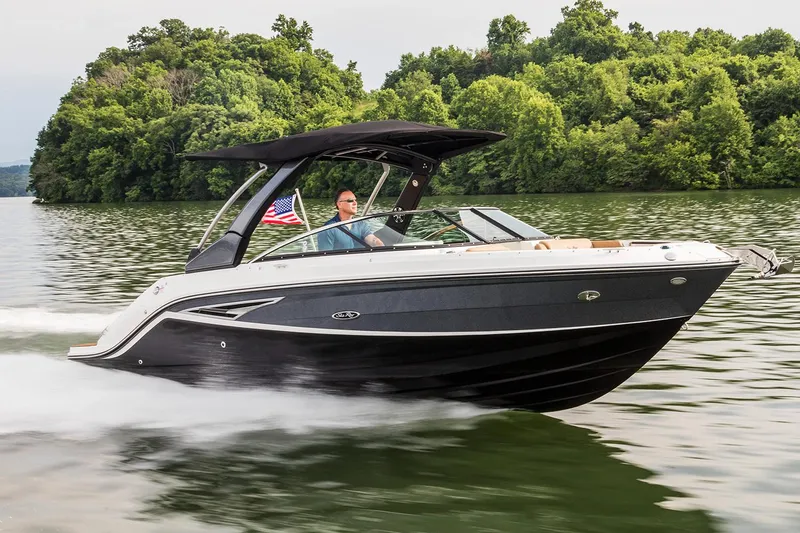 Slide: The Image of Top view of 2020 Sea Ray SLX 250 boat with blue canopy and tan seating. - 2