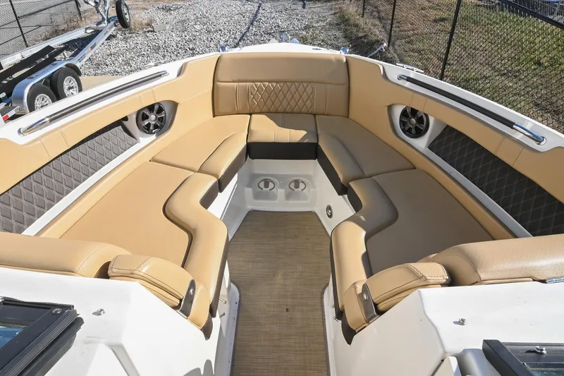 Slide: The Image of Luxurious interior of 2020 Sea Ray SLX 250 boat with tan seating and speakers. - 29