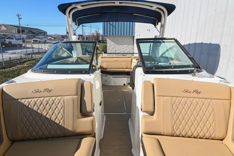 Slide: The Image of 2020 Sea Ray SLX 250 boat interior with tan leather seating and open cockpit. - 30