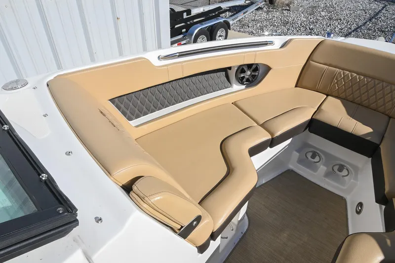Slide: The Image of 2020 Sea Ray SLX 250 boat interior with tan leather seating and speaker. - 31