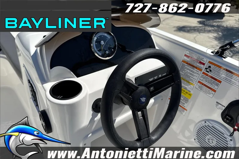 Slide: The Image of 2026 Bayliner Element E16 boat dashboard with steering wheel and control panel. - 15