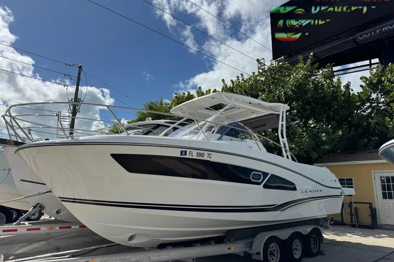 Slide: The Image of 2021 Jeanneau Leader 9.0 WA boat on trailer under clear sky. - 0