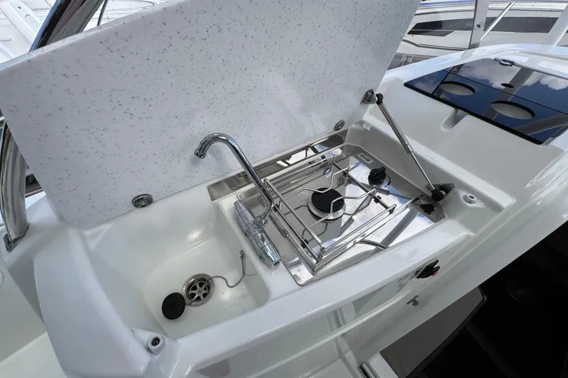 Slide: The Image of 2021 Jeanneau Leader 9.0 WA boat kitchen with sink and stove. - 16
