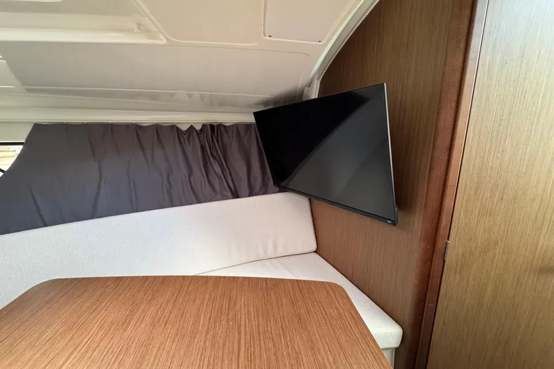 Slide: The Image of Interior of 2021 Jeanneau Leader 9.0 WA with TV and seating area. - 22