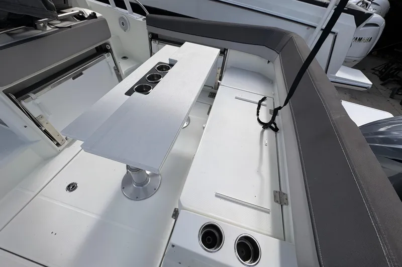 Slide: The Image of 2021 Jeanneau Leader 9.0 WA boat interior with seating and table setup. - 4