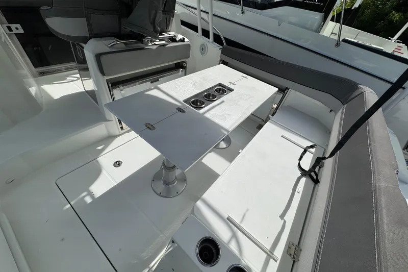 Slide: The Image of 2021 Jeanneau Leader 9.0 WA boat interior with seating and table setup. - 5
