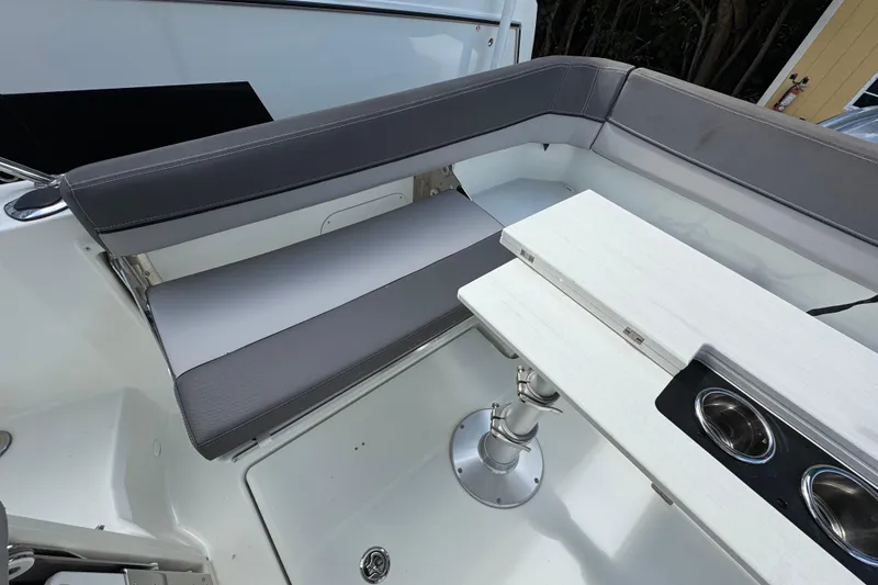 Slide: The Image of 2021 Jeanneau Leader 9.0 WA boat interior with gray seating and white table. - 6
