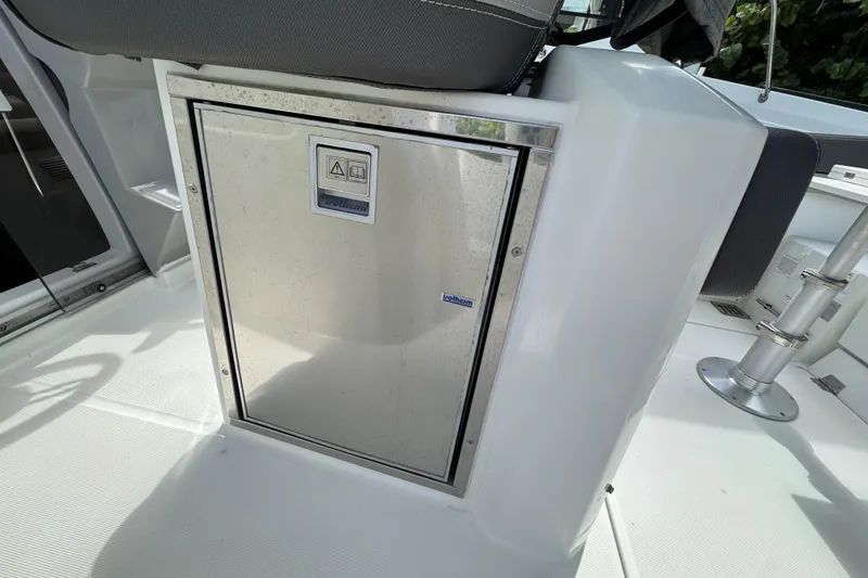Slide: The Image of 2021 Jeanneau Leader 9.0 WA boat interior with built-in storage compartment. - 9