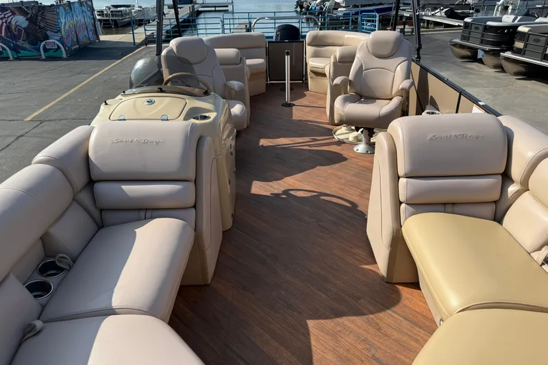 Slide: The Image of 2017 South Bay 523RS-DC pontoon boat with beige seating and wood-style flooring. - 10