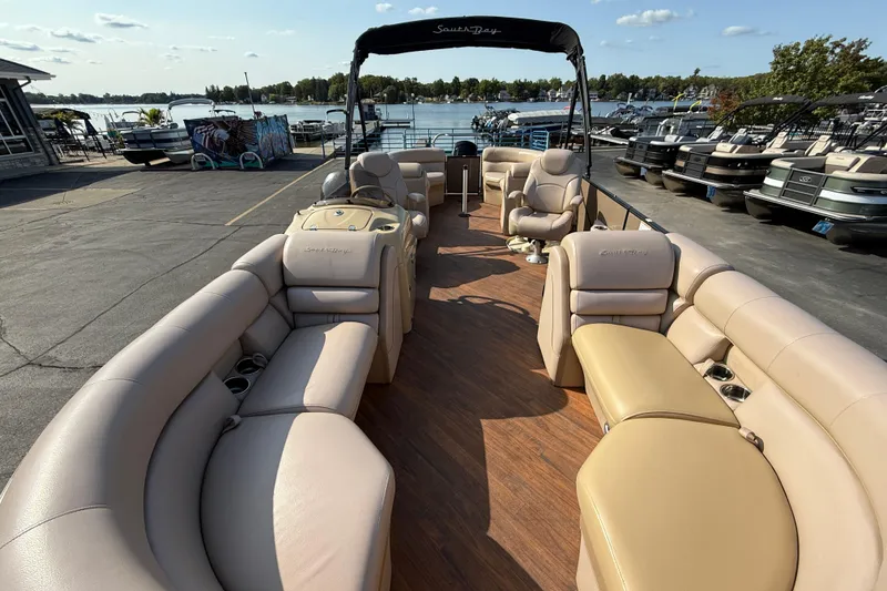 Slide: The Image of 2017 South Bay 523RS-DC pontoon boat with spacious seating, docked by a scenic lake. - 11