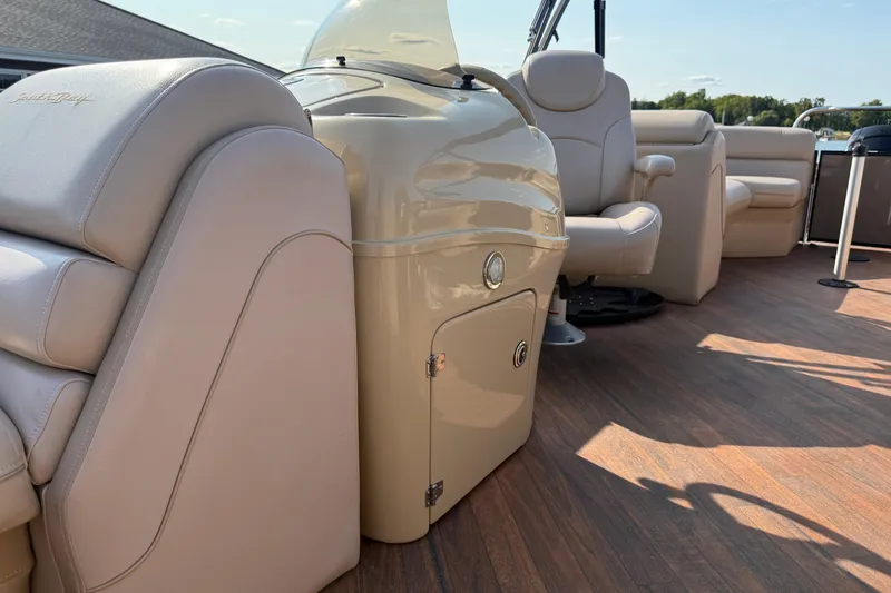 Slide: The Image of 2017 South Bay 523RS-DC boat interior with beige seating and wood flooring. - 14
