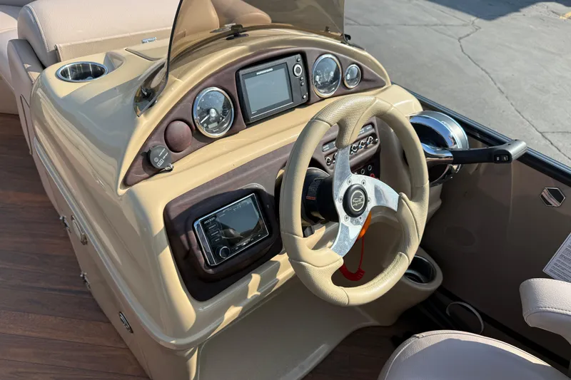 Slide: The Image of 2017 South Bay 523RS-DC boat dashboard with steering wheel and control panel. - 17