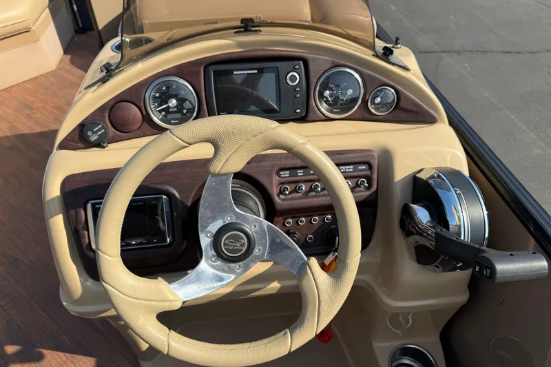 Slide: The Image of 2017 South Bay 523RS-DC boat dashboard with steering wheel and control panel. - 19