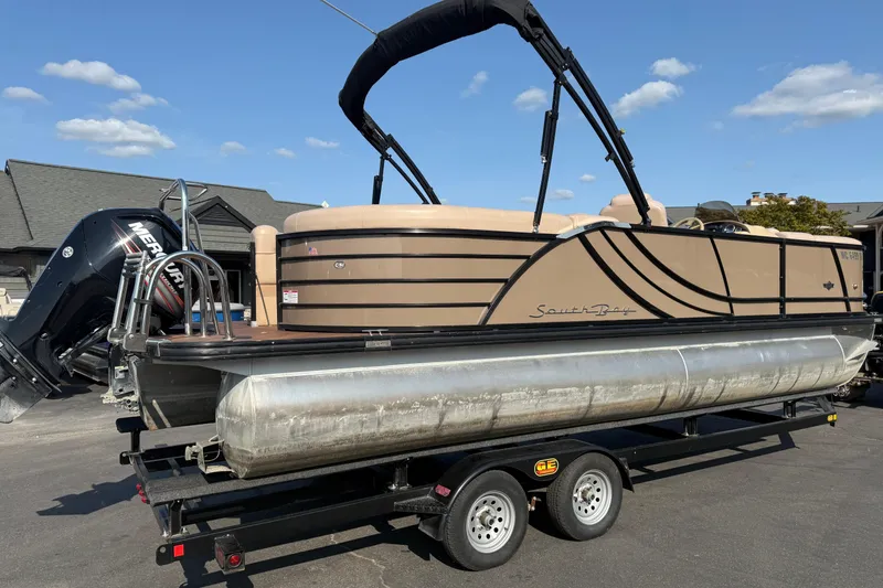 Slide: The Image of 2017 South Bay 523RS-DC pontoon boat on trailer, featuring a Mercury outboard motor. - 7