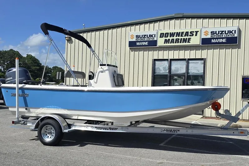 The Image of 2026 Sundance DX20 boat on trailer at Downeast Marine dealership. - 1