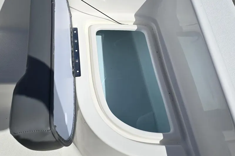 Slide: The Image of Sundance DX20 2026 boat interior with open storage compartment. - 11