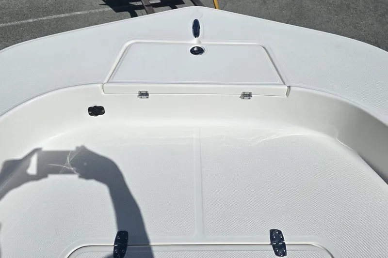 Slide: The Image of Bow of 2026 Sundance DX20 boat with storage compartment and clean deck design. - 13