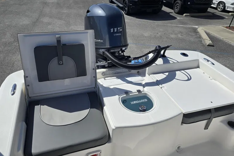 Slide: The Image of 2026 Sundance DX20 boat with Yamaha 115 engine, featuring sleek seating and storage. - 5