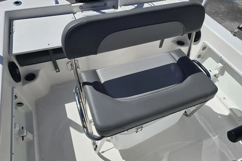 Slide: The Image of 2026 Sundance DX20 boat interior with cushioned seating and storage. - 6