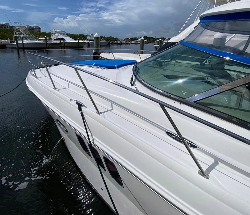 Slide: The Image of 2008 Sea Ray 38 Sundancer yacht docked at marina under cloudy sky. - 3