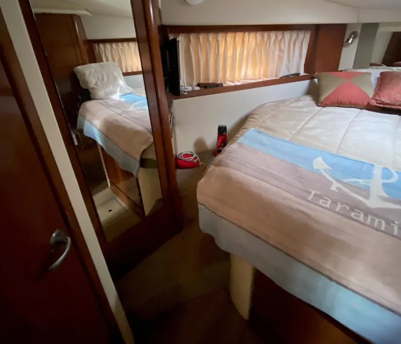 Slide: The Image of Interior of 2008 Sea Ray 38 Sundancer yacht bedroom with cozy bedding and mirror. - 8