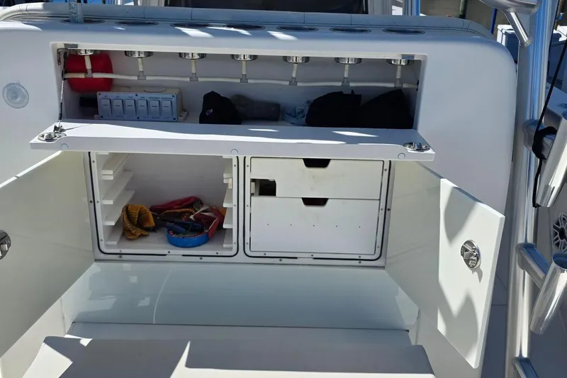 Slide: The Image of 2020 SeaVee 390Z boat storage compartment with open shelves and fishing gear. - 12