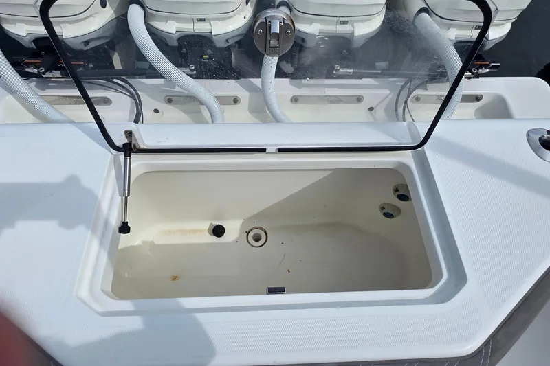 Slide: The Image of 2020 SeaVee 390Z boat with open storage compartment and visible engine hoses. - 13