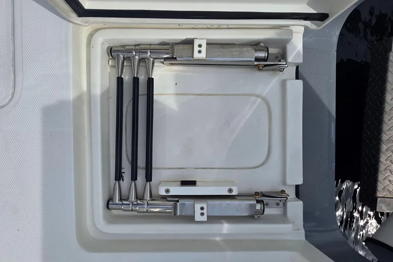 Slide: The Image of Compartment of 2020 SeaVee 390Z boat showing hydraulic components and storage. - 14