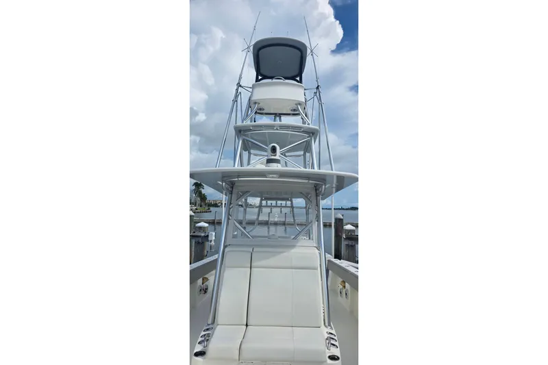 Slide: The Image of 2020 SeaVee 390Z boat with tower, docked under a cloudy sky. - 18