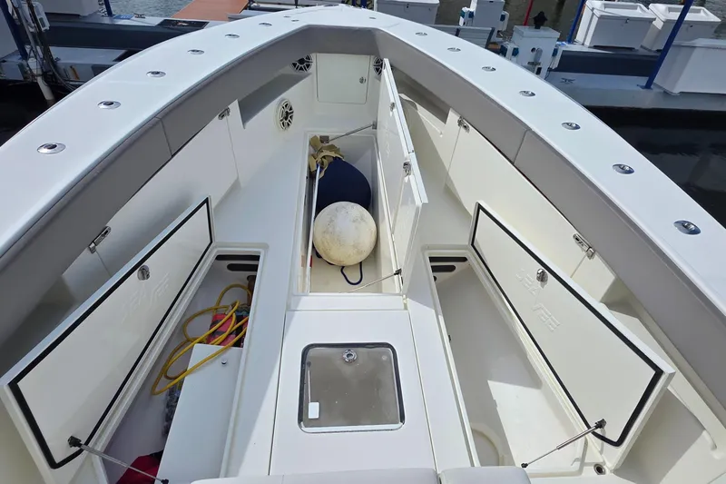 Slide: The Image of 2020 SeaVee 390Z boat deck with open storage compartments and marine equipment. - 20