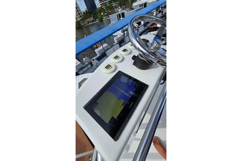 Slide: The Image of 2020 SeaVee 390Z boat helm with navigation display and steering wheel. - 26