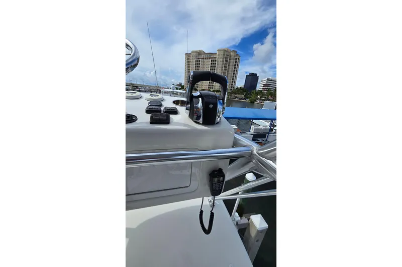 Slide: The Image of 2020 SeaVee 390Z boat dashboard with controls, cityscape in background. - 28