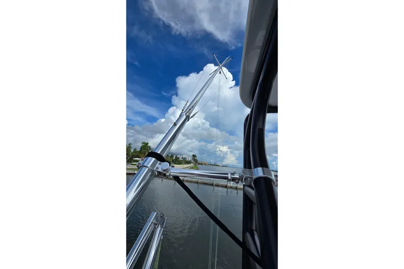 Slide: The Image of 2020 SeaVee 390Z boat with outriggers against a cloudy sky and waterfront. - 31
