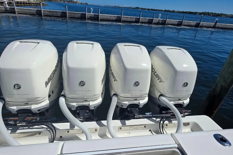 Slide: The Image of 2020 SeaVee 390Z boat with four Mercury outboard engines docked by the water. - 7