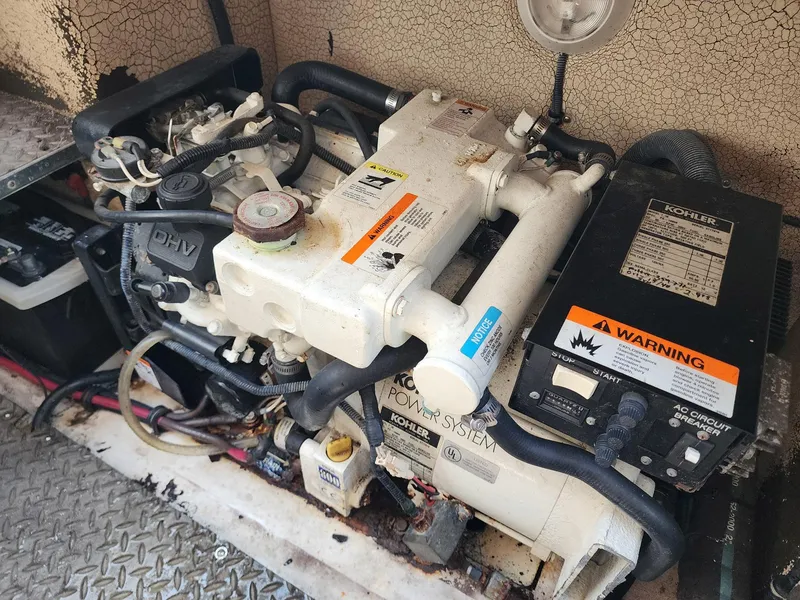 Slide: The Image of Engine compartment of a 2002 Formula 31 PC boat, featuring a Kohler power system. - 13