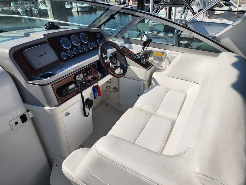 Slide: The Image of 2002 Formula 31 PC boat cockpit with white seating and control panel. - 2