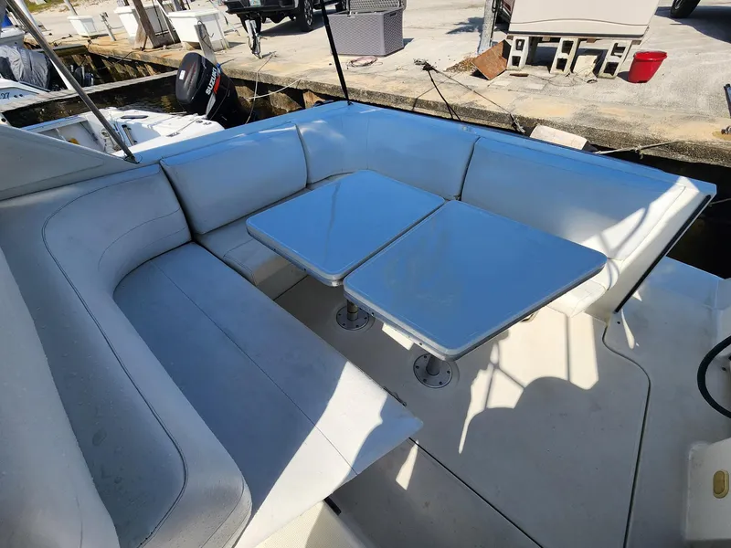 Slide: The Image of 2002 Formula 31 PC boat with white seating and dual tables on deck. - 5