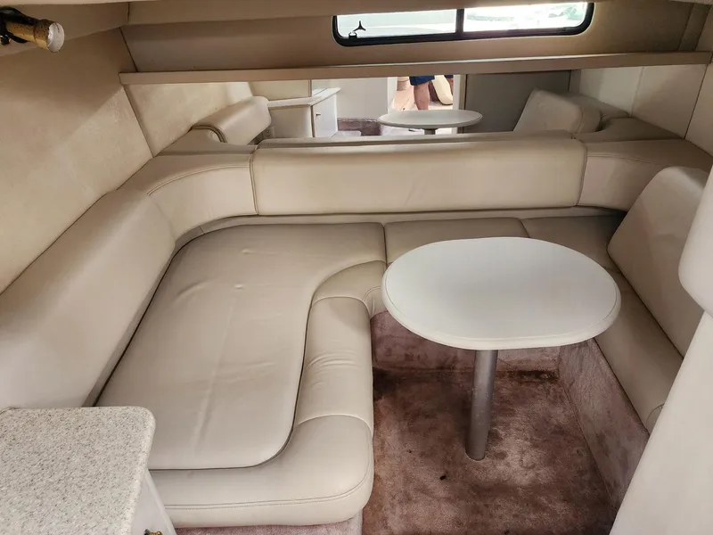 Slide: The Image of 2002 Formula 31 PC yacht interior with beige leather seating and round table. - 9