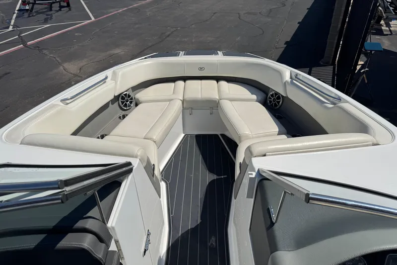 Slide: The Image of 2013 Cobalt 26SD WSS boat interior with white seating and speakers. - 10