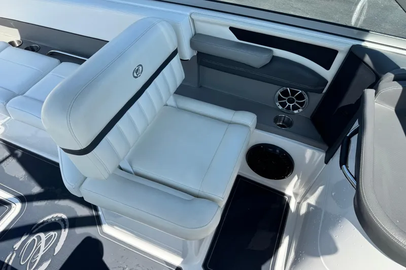 Slide: The Image of 2013 Cobalt 26SD WSS boat interior with white seating and speaker system. - 5