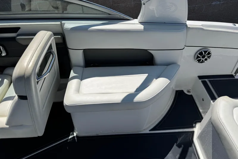 Slide: The Image of 2013 Cobalt 26SD WSS boat interior with white leather seating and speaker detail. - 7