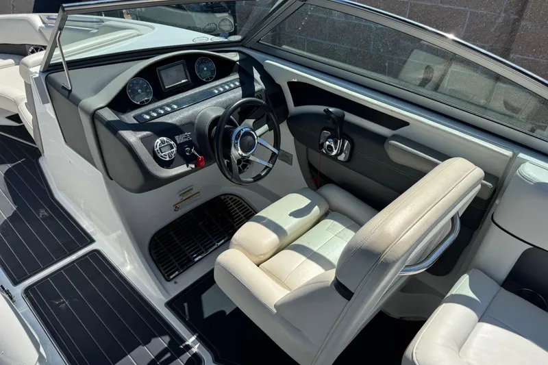 Slide: The Image of 2013 Cobalt 26SD WSS boat interior with steering wheel and dashboard controls. - 8